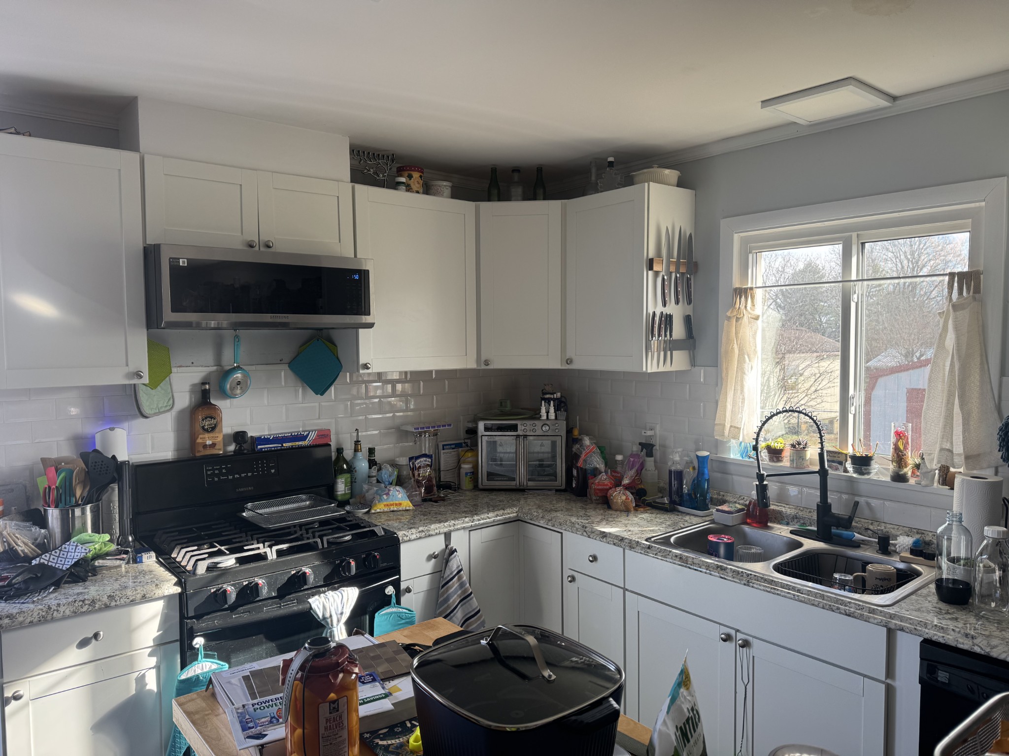 611 Estes Street Smithville, TN 37166 - Photo 3 of 9 a kitchen with a sink a stove and a refrigerator