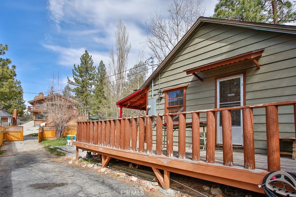 a view of wooden house with a wooden fence
