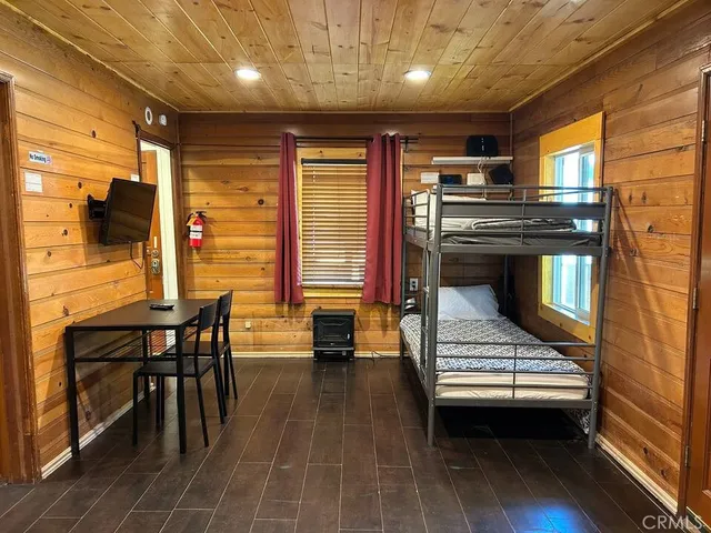 a kitchen with stove and chairs