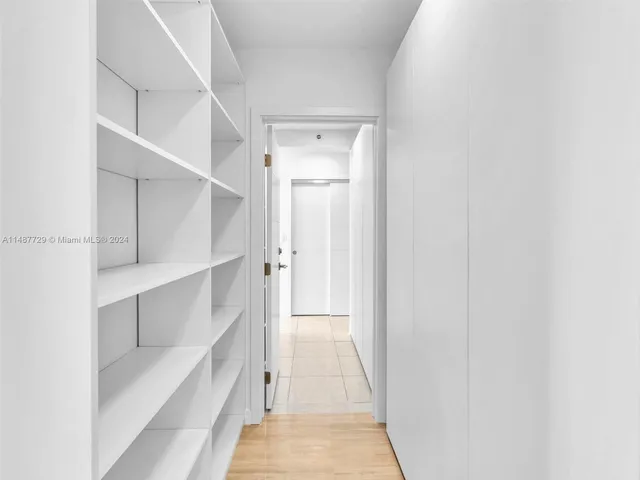 a view of an empty room with a kitchen
