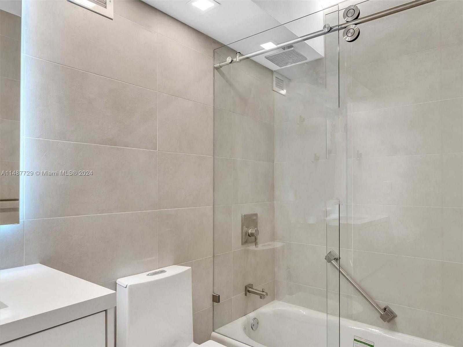 4101 Pine Tree Drive, Unit 621 620 Miami Beach, FL 33140 - Photo 33 of 73 a bathroom with a shower and toilet