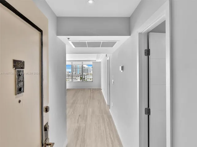 a view of a kitchen with wooden floor and a window