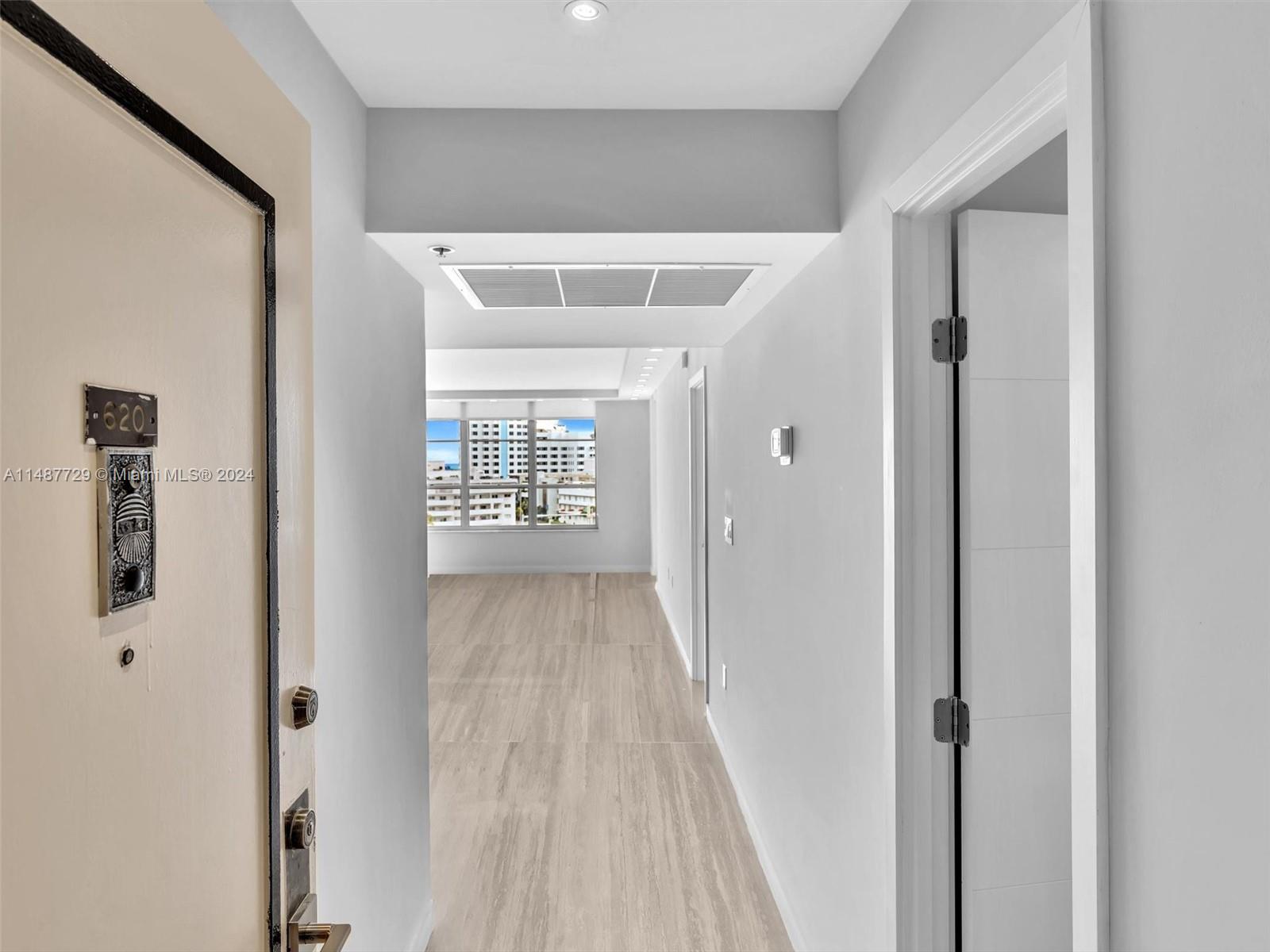 4101 Pine Tree Drive, Unit 621 620 Miami Beach, FL 33140 - Photo 36 of 73 a view of a hallway with wooden floor and windows