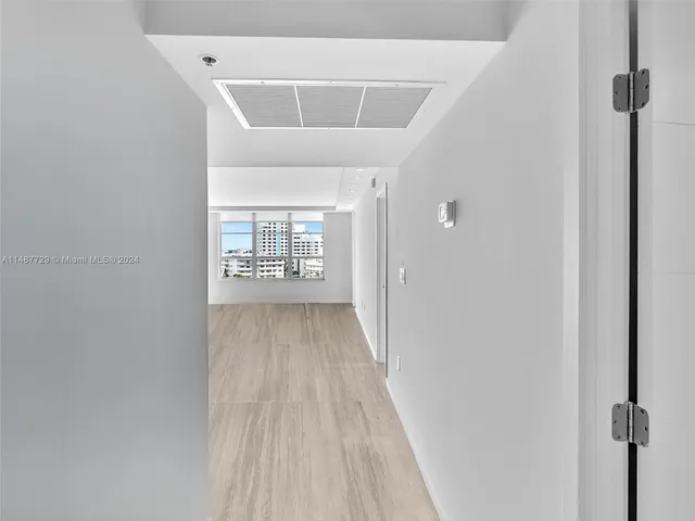 a view of water heater room with wooden floor