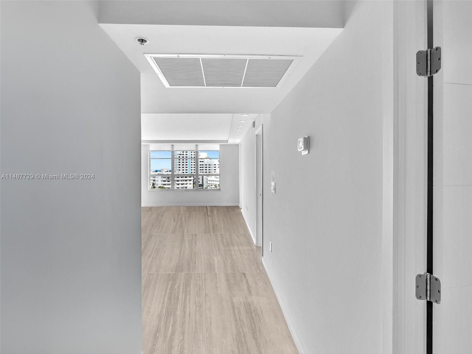 4101 Pine Tree Drive, Unit 621 620 Miami Beach, FL 33140 - Photo 37 of 73 a view of a hallway with wooden floor
