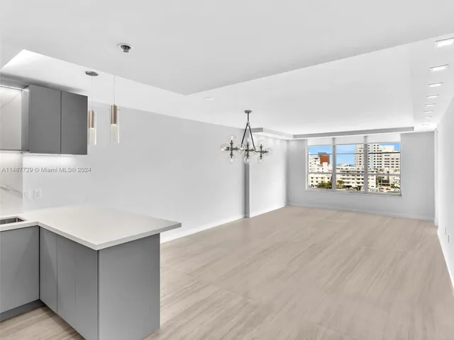 a kitchen with stainless steel appliances granite countertop a sink and a refrigerator