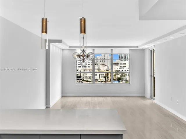 a kitchen with stainless steel appliances granite countertop a sink and a refrigerator