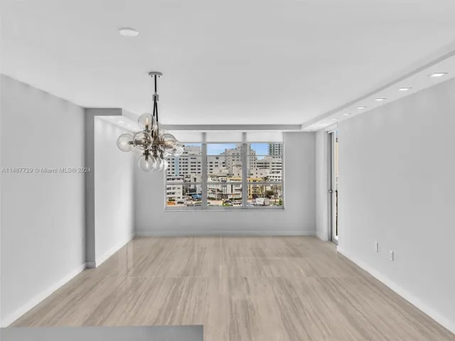 a view of a kitchen with a sink and refrigerator