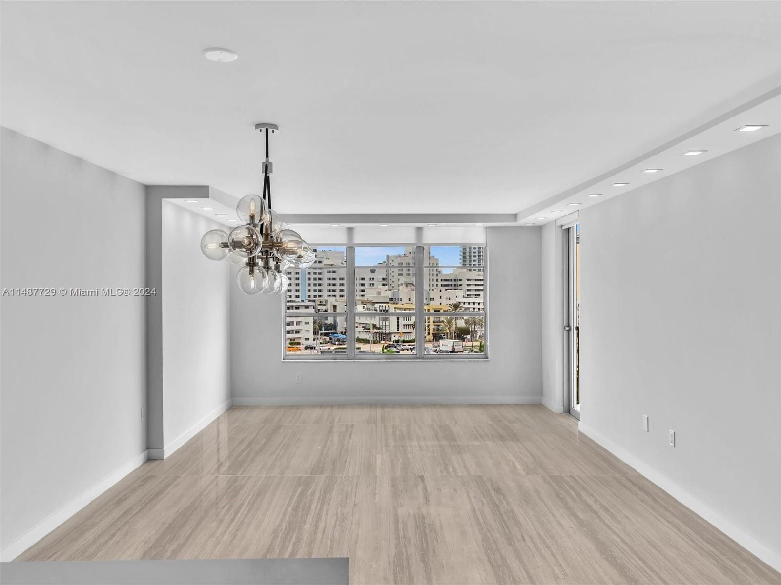 4101 Pine Tree Drive, Unit 621 620 Miami Beach, FL 33140 - Photo 43 of 73 a view of an empty room with wooden floor and a window