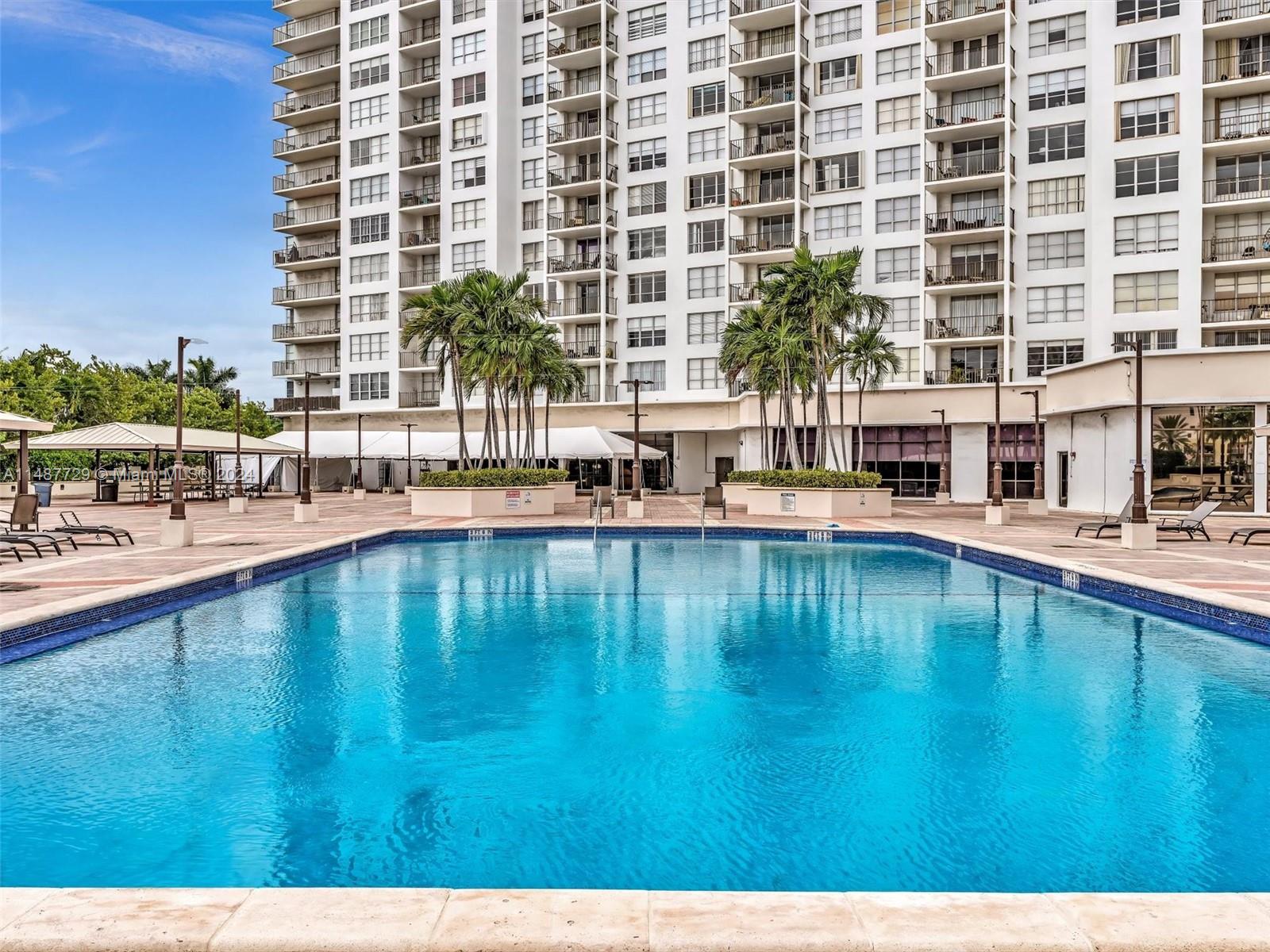 4101 Pine Tree Drive, Unit 621 620 Miami Beach, FL 33140 - Photo 69 of 73 a swimming pool with outdoor seating and yard