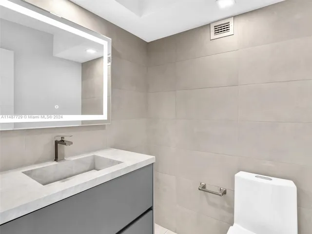 a view of a refrigerator in kitchen and wooden floor