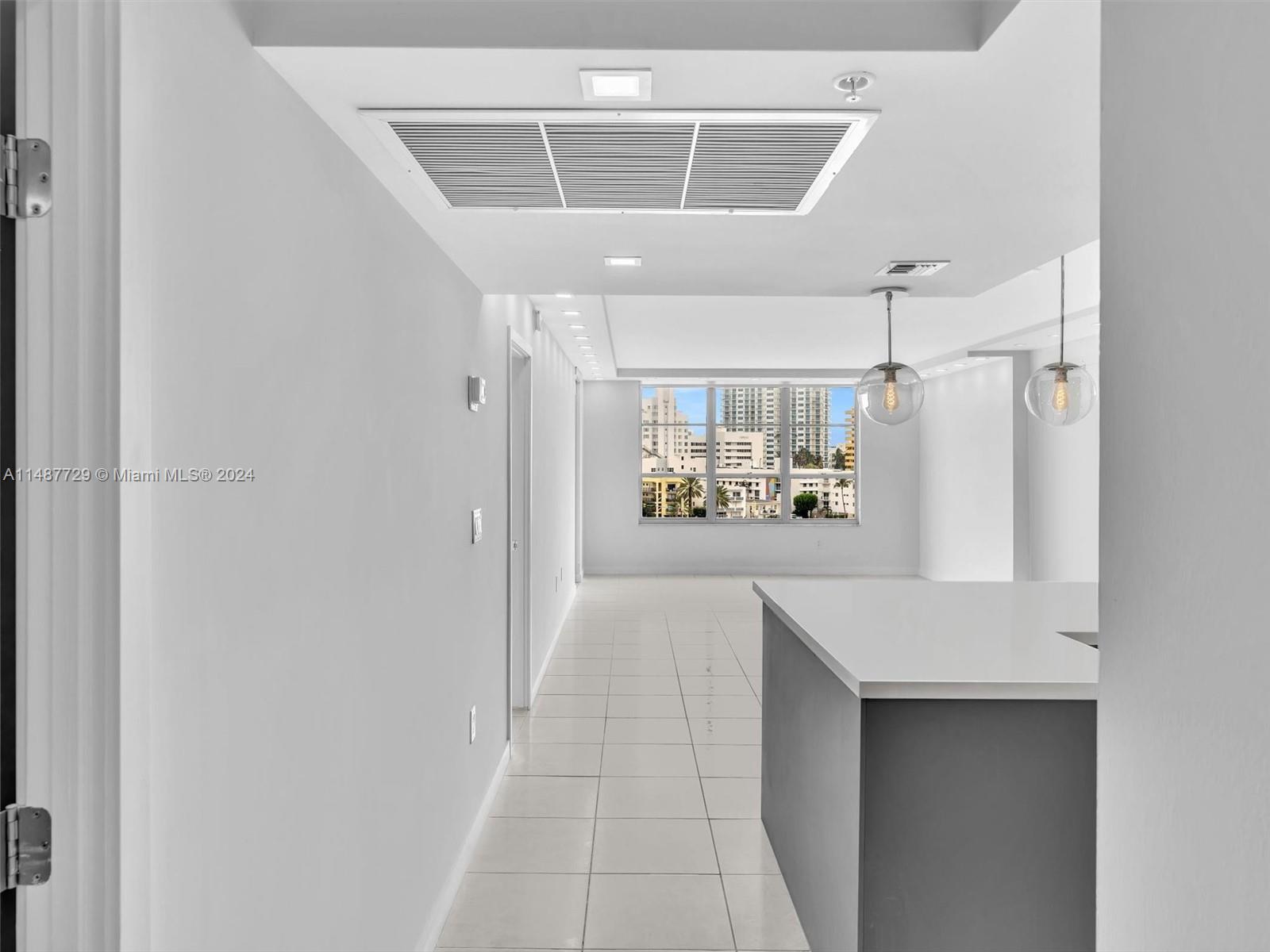 4101 Pine Tree Drive, Unit 621 620 Miami Beach, FL 33140 - Photo 9 of 73 a view of a refrigerator in kitchen and wooden floor