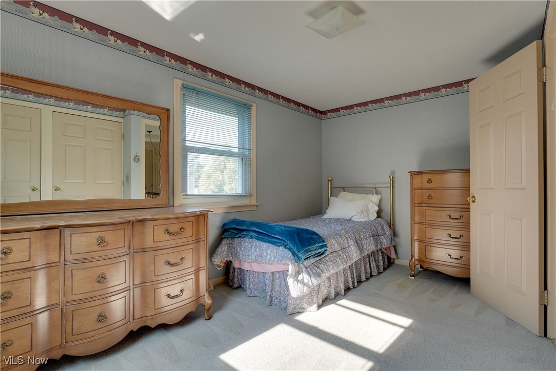 4939 Shankland Road Willoughby, OH 44094 - Photo 13 of 24 Bedroom with light colored carpet and baseboards