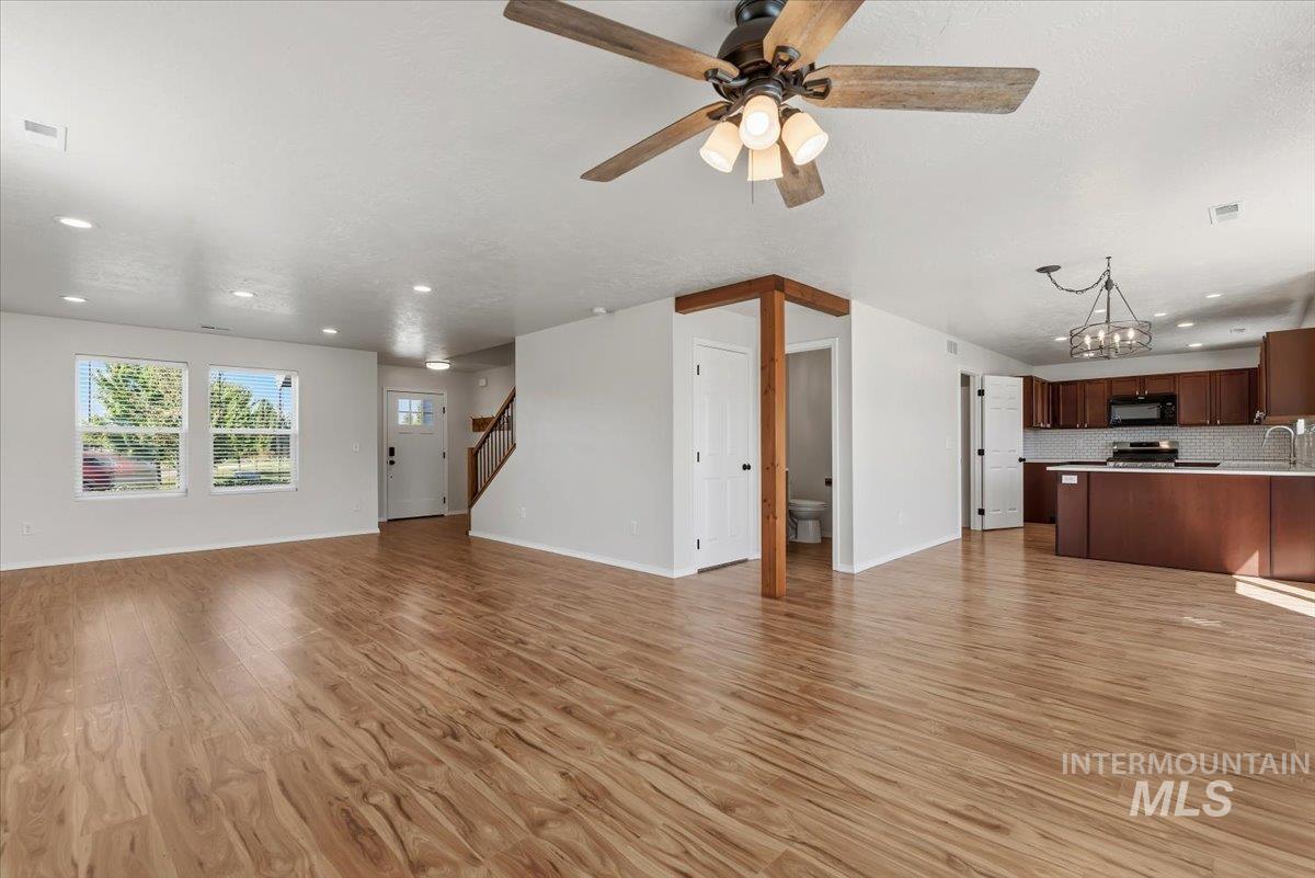 12310 West Hidden Point Drive Star, ID 83669 - Photo 27 of 48 Expansive interior featuring wood-finish flooring, recessed lighting, and a contemporary ceiling fan with integrated lighting