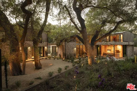 a view of a brick house with a yard