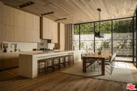 a kitchen with a stove a sink and cabinets