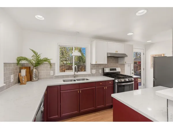 a kitchen with a sink a stove and refrigerator