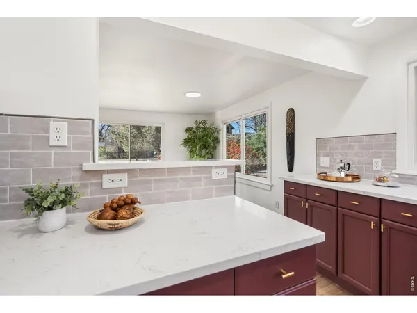 a kitchen with a sink a counter space and a window