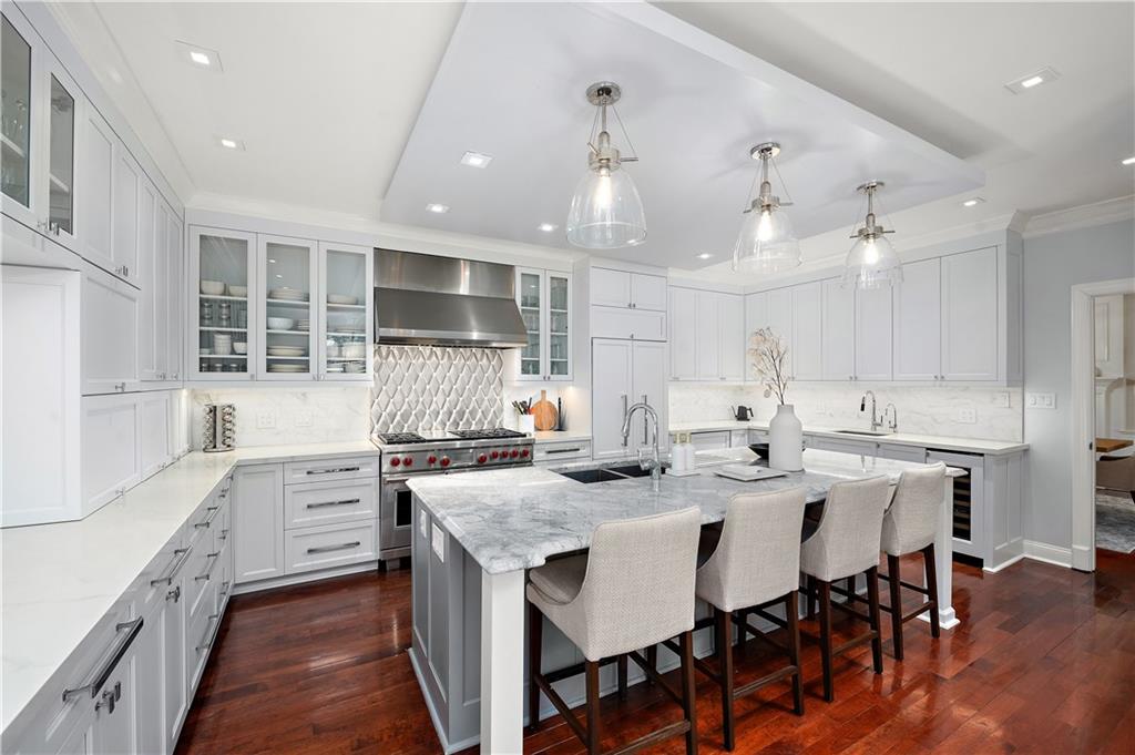 515 Maple Lane Sewickley, PA 15143 - Photo 12 of 42 a kitchen with stainless steel appliances kitchen island granite countertop a table chairs sink and cabinets