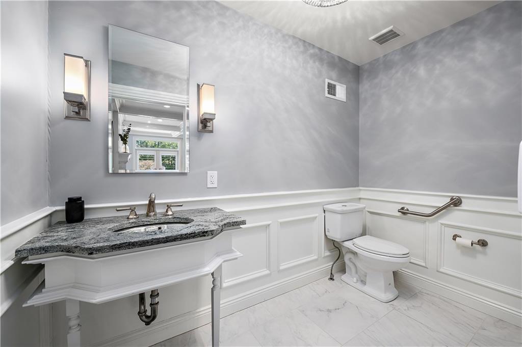 515 Maple Lane Sewickley, PA 15143 - Photo 20 of 42 a bathroom with a granite countertop toilet sink and mirror