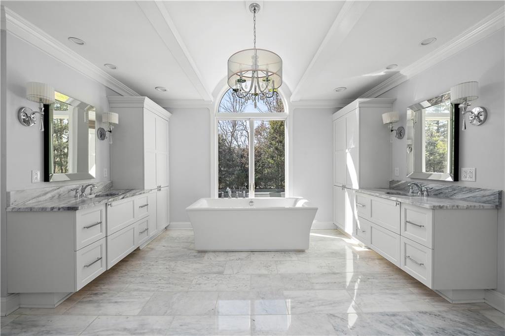 515 Maple Lane Sewickley, PA 15143 - Photo 25 of 42 a large spacious bathroom with a granite countertop double vanity sink a mirror a bathtub and window