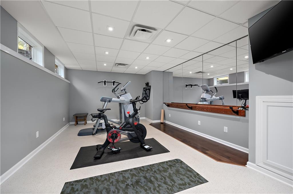 515 Maple Lane Sewickley, PA 15143 - Photo 36 of 42 a room with gym equipment and a flat screen tv