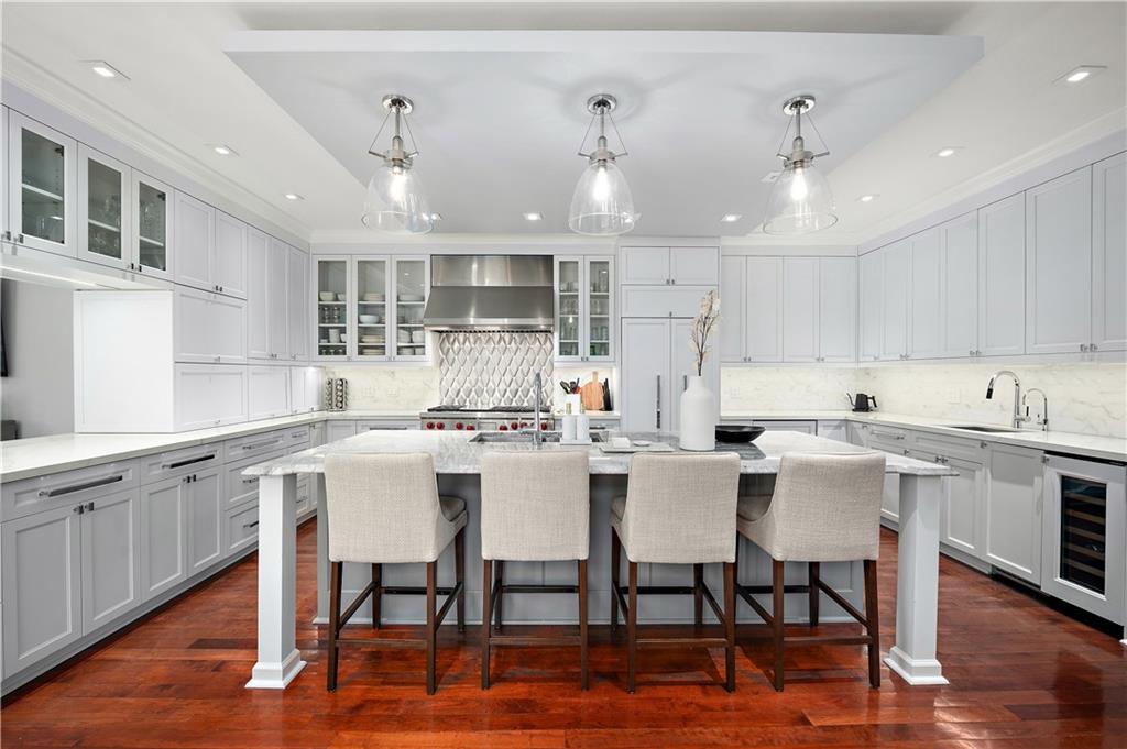 515 Maple Lane Sewickley, PA 15143 - Photo 10 of 42 a kitchen with a dining table chairs cabinets wooden floor and appliances