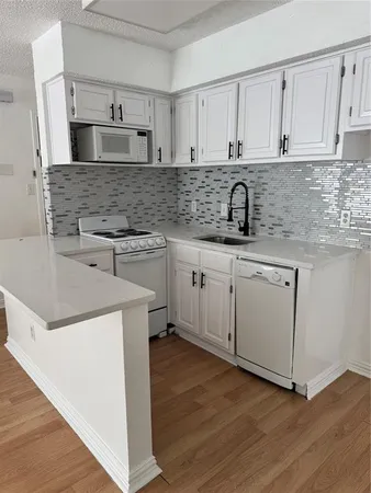 a kitchen with stainless steel appliances granite countertop a sink and cabinets