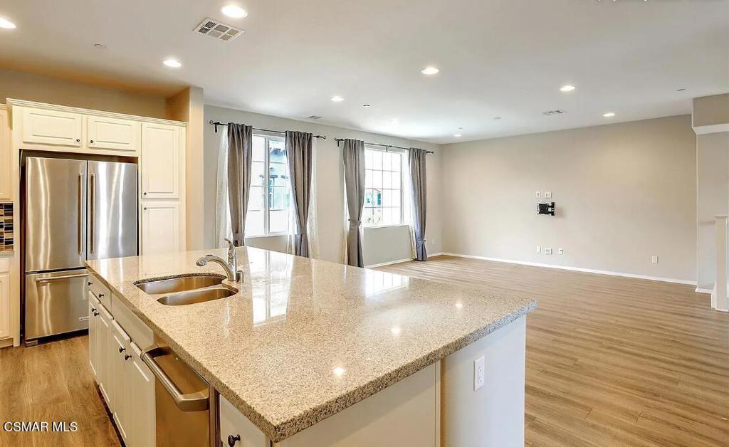 458 Stratus Lane, Unit 5 Simi Valley, CA 93065 - Photo 4 of 13 a kitchen with granite countertop a sink and refrigerator