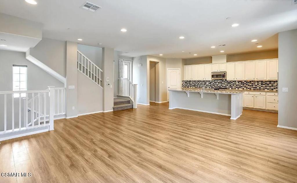 458 Stratus Lane, Unit 5 Simi Valley, CA 93065 - Photo 5 of 13 a view of living room with kitchen island stainless steel appliances wooden floor and living room view