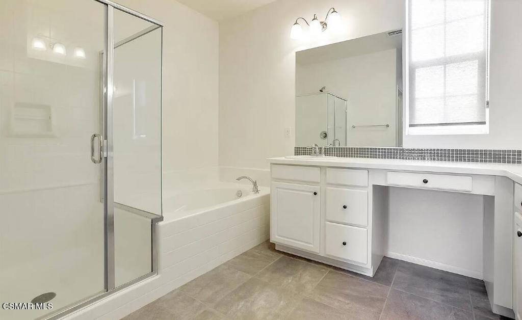 458 Stratus Lane, Unit 5 Simi Valley, CA 93065 - Photo 7 of 13 a spacious bathroom with a double vanity sink a mirror and a bathtub