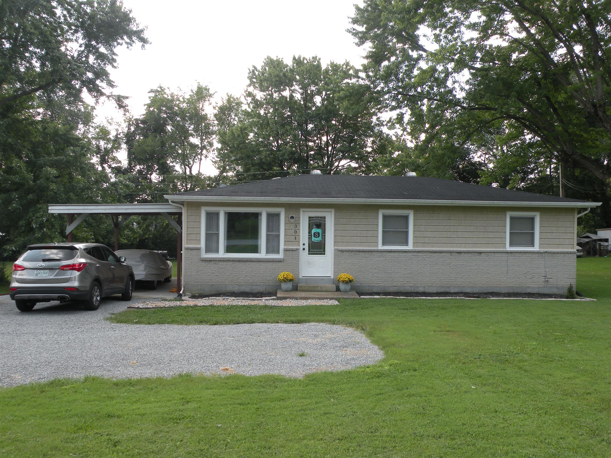301 Fowler Ford Road Portland, TN 37148 - Photo 1 of 22 a front view of a house with a garden and trees