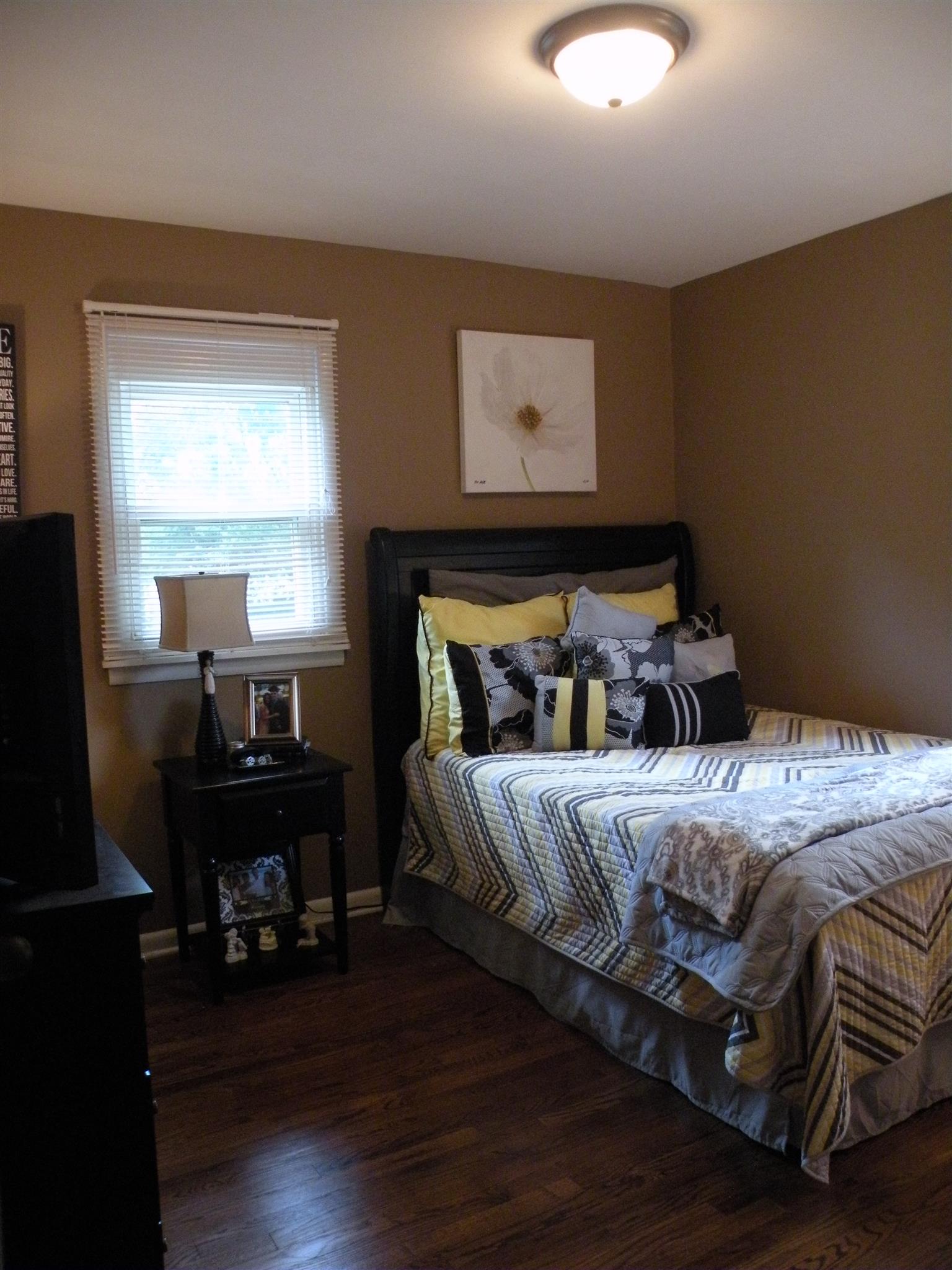 301 Fowler Ford Road Portland, TN 37148 - Photo 15 of 22 a bedroom with a bed and wooden floor