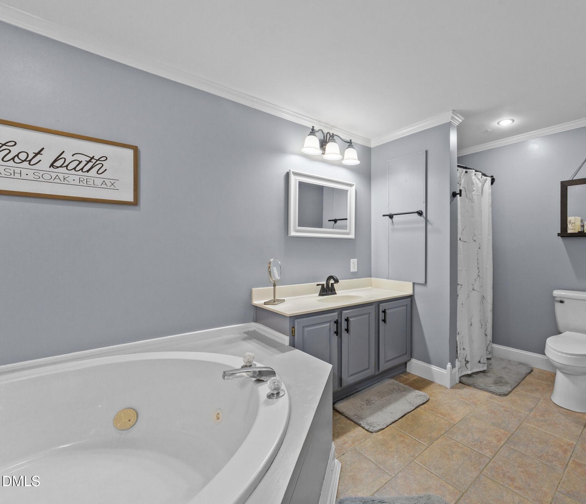 2465 Shoeheel Road Selma, NC 27576 - Photo 11 of 36 a spacious bathroom with a tub sink shower and mirror