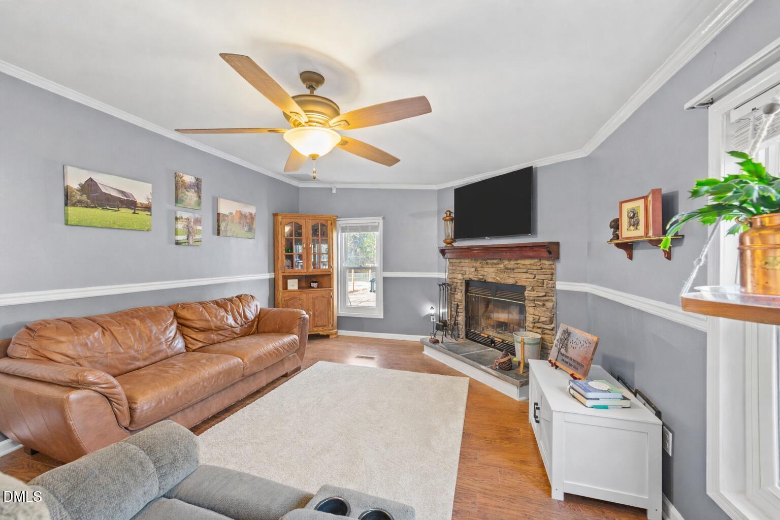 2465 Shoeheel Road Selma, NC 27576 - Photo 12 of 36 a living room with furniture a fireplace and a flat screen tv