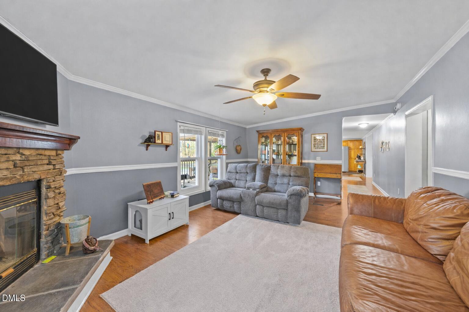 2465 Shoeheel Road Selma, NC 27576 - Photo 13 of 36 a living room with furniture fireplace and a flat screen tv