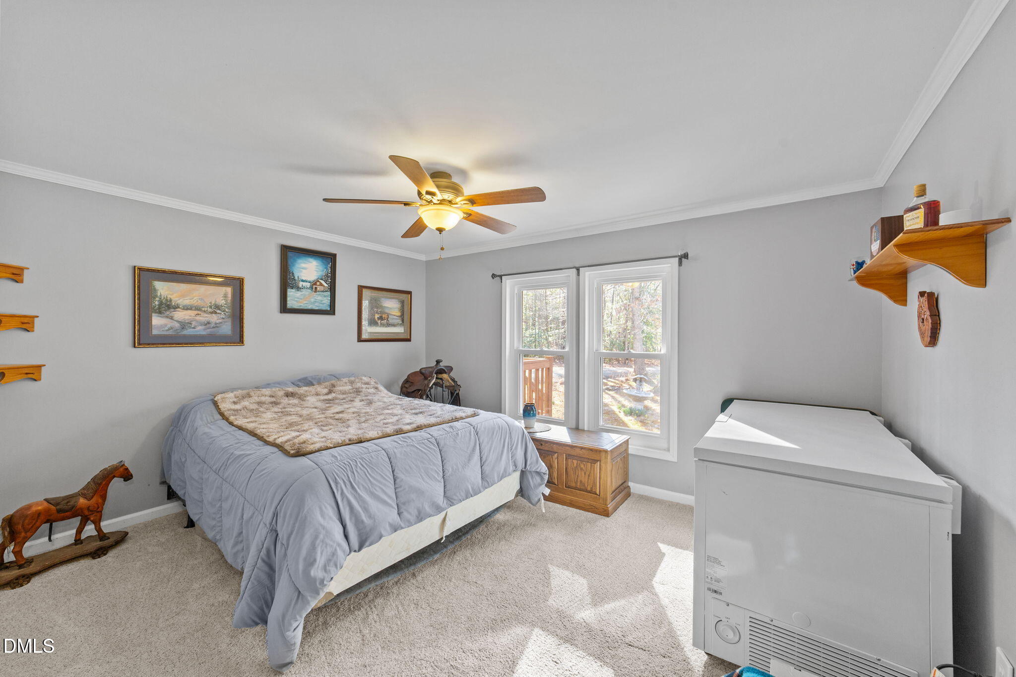 2465 Shoeheel Road Selma, NC 27576 - Photo 15 of 36 a bedroom with a bed and a chandelier