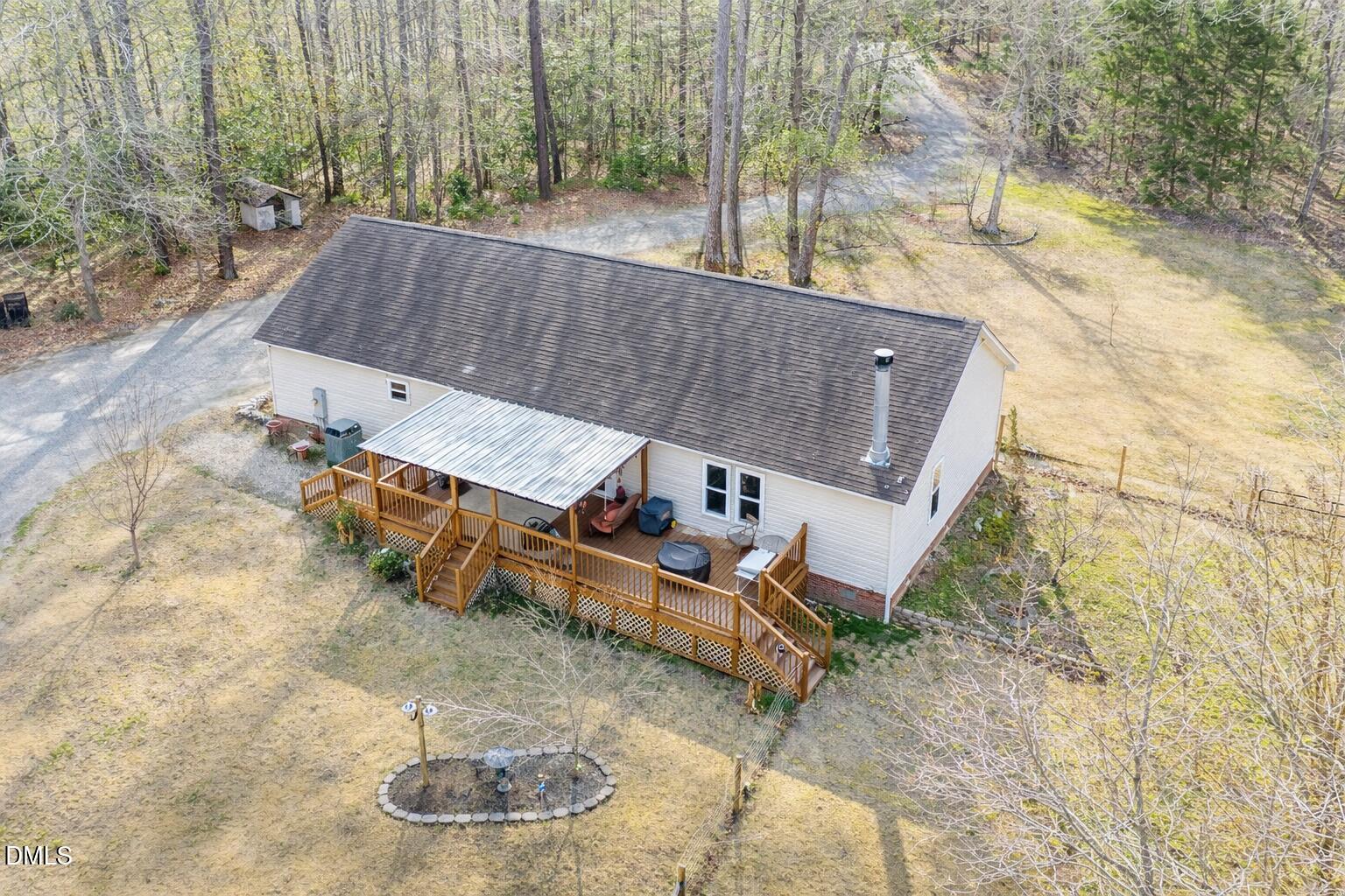 2465 Shoeheel Road Selma, NC 27576 - Photo 18 of 36 a view of a patio with table and chairs with wooden fence