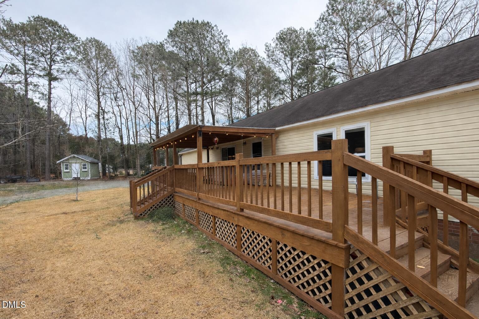 2465 Shoeheel Road Selma, NC 27576 - Photo 19 of 36 a view of a house with a wooden deck