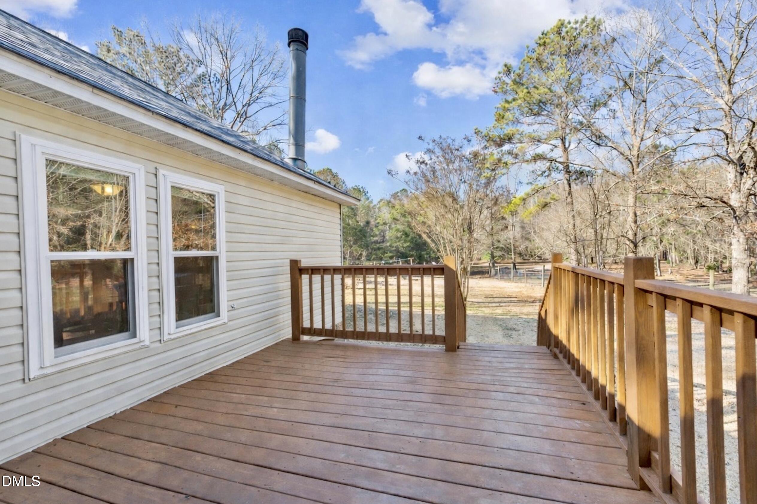 2465 Shoeheel Road Selma, NC 27576 - Photo 21 of 36 a view of a balcony with wooden floor and stairs