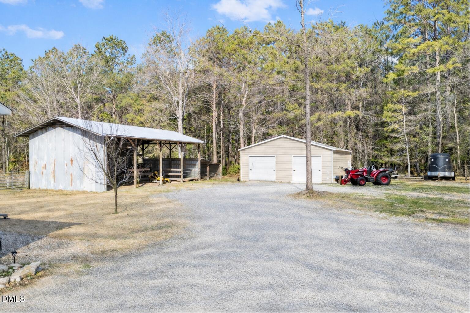 2465 Shoeheel Road Selma, NC 27576 - Photo 24 of 36 a view of a house with a yard and garage
