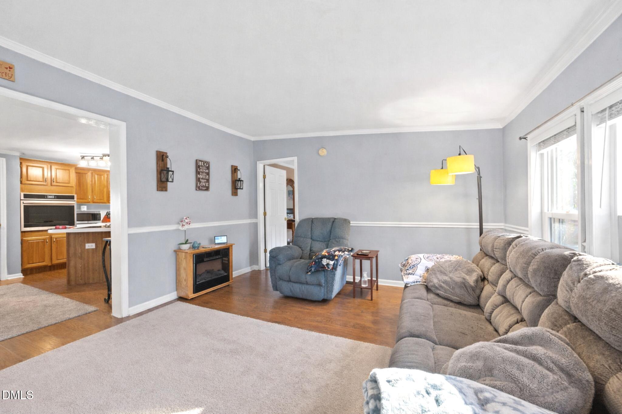 2465 Shoeheel Road Selma, NC 27576 - Photo 4 of 36 a living room with furniture and wooden floor