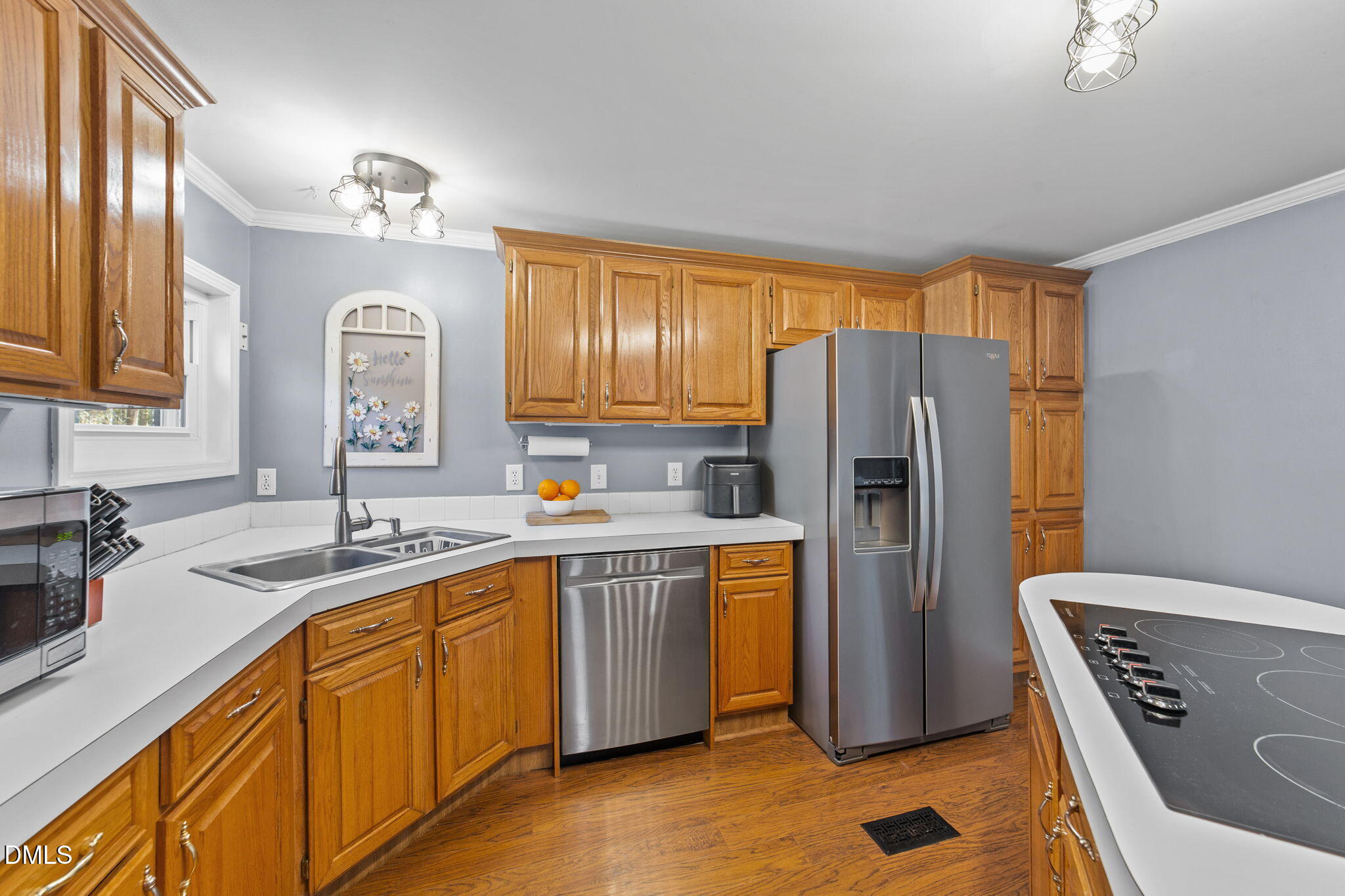2465 Shoeheel Road Selma, NC 27576 - Photo 6 of 36 a kitchen with stainless steel appliances granite countertop a refrigerator a sink dishwasher and wooden cabinets with wooden floor