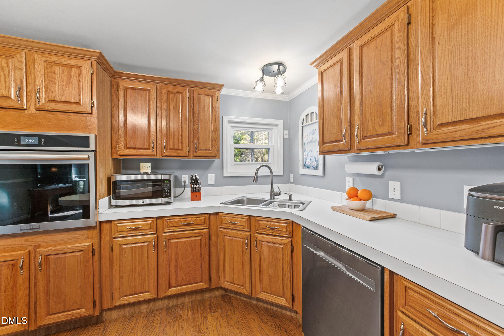 2465 Shoeheel Road Selma, NC 27576 - Photo 7 of 36 a kitchen with stainless steel appliances granite countertop a sink dishwasher stove top oven and cabinets with wooden floor