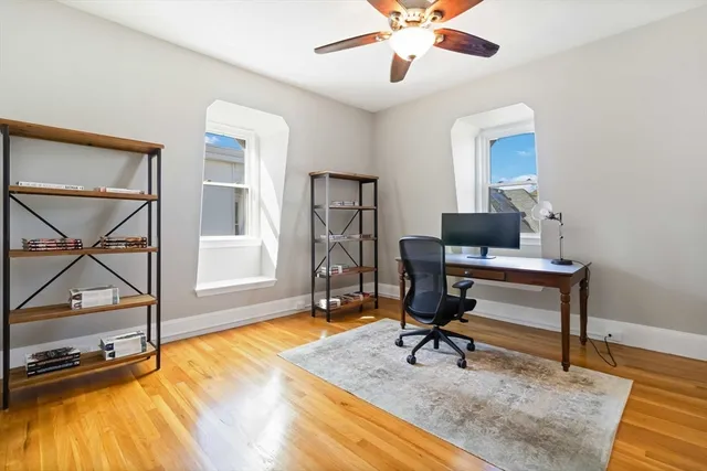 a view of a workspace with furniture and a window