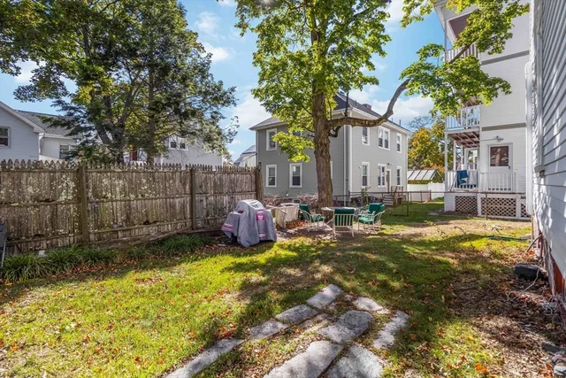 a view of a backyard with a large tree