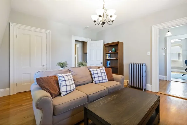 a living room with furniture or couch and a chandelier