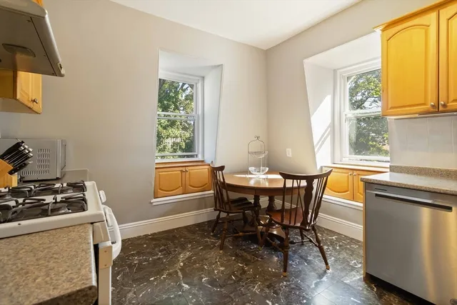 a dining room with furniture and a window