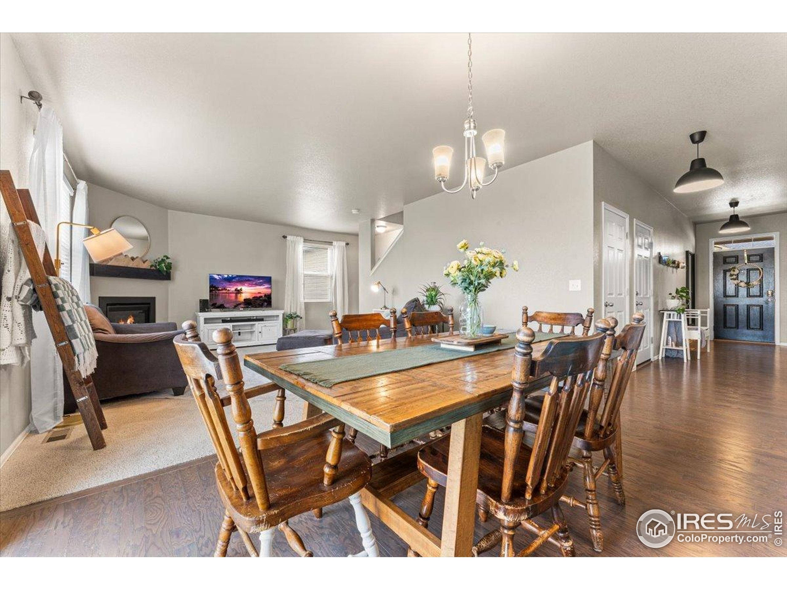6747 Grainery Road Timnath, CO 80547 - Photo 16 of 42 a view of a dining room with furniture and wooden floor
