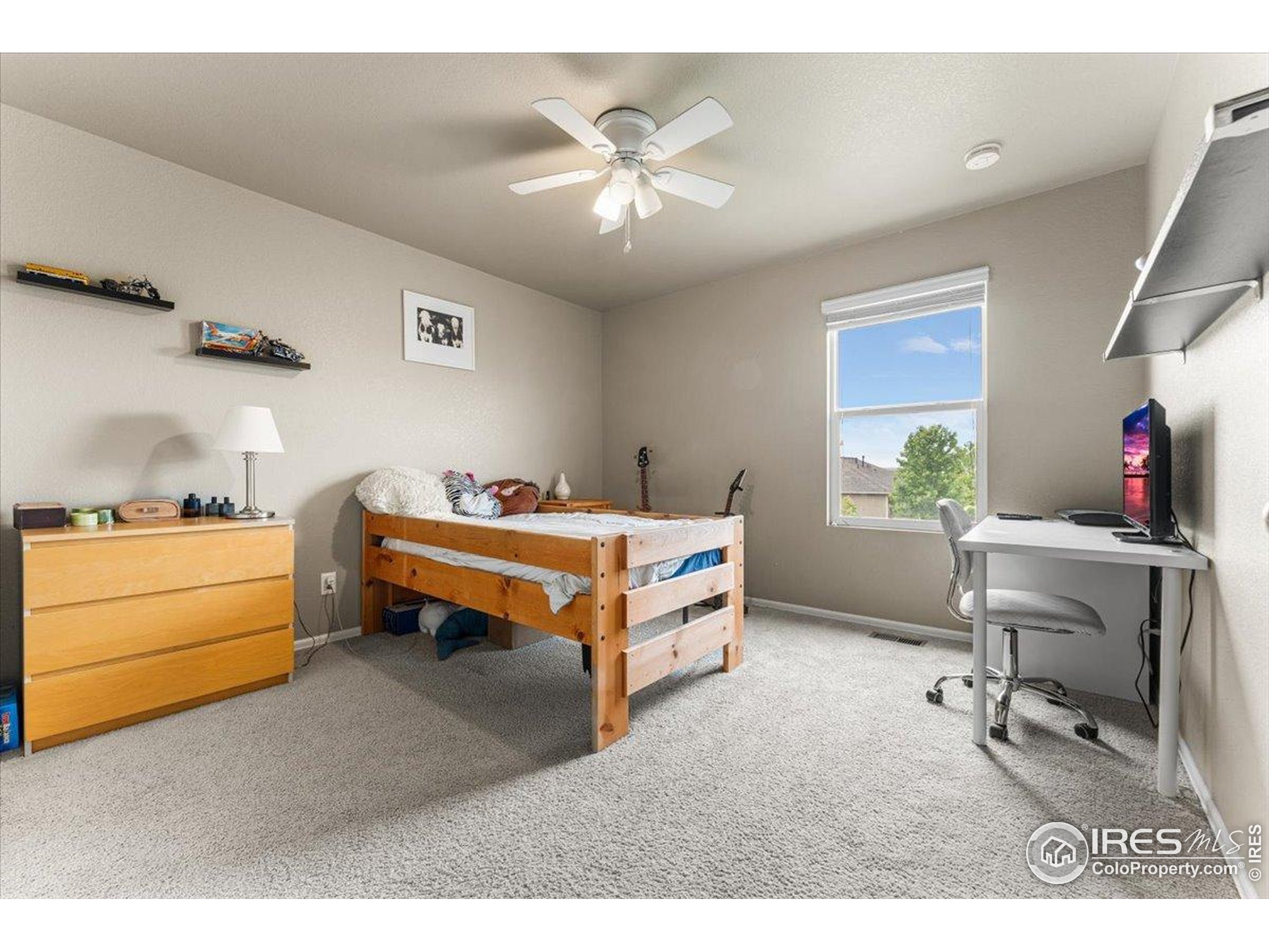 6747 Grainery Road Timnath, CO 80547 - Photo 23 of 42 a bedroom with furniture and a window